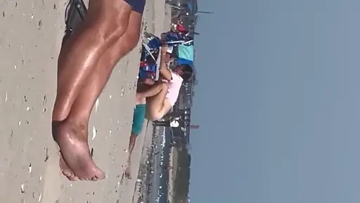 Sister rides her brother at the beach